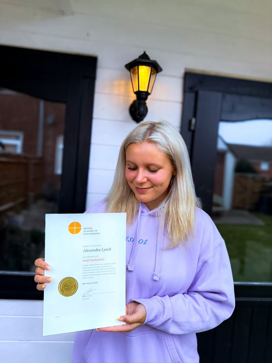 Alex holding her British Academy of Photography certificate