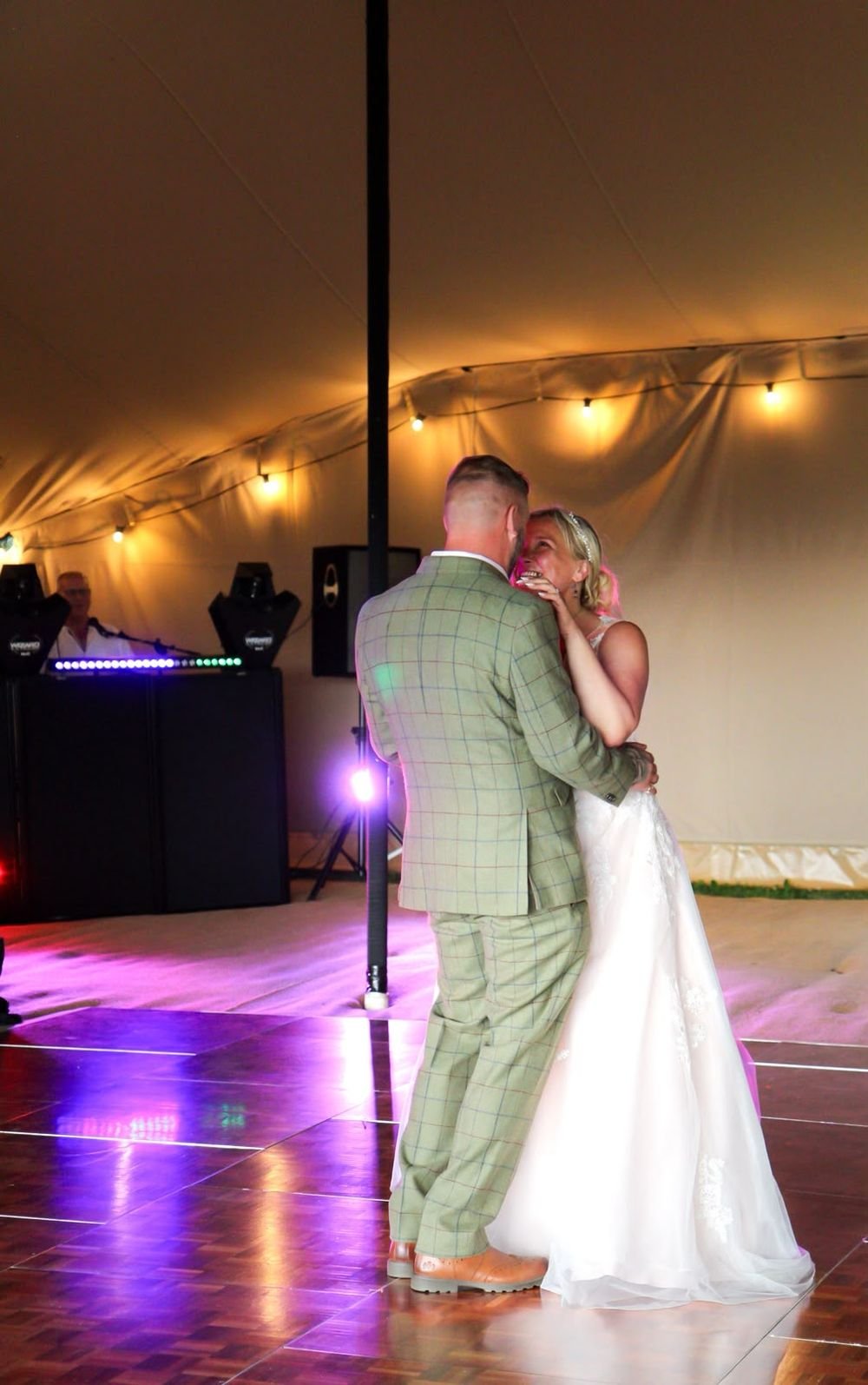 First dance under festoon lights in a marquee